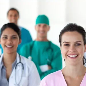 A group of happy people in healthcare industry indicating how the MSP helps healthcare organizations with its managed IT services empowering the healthcare workforce.